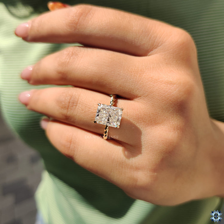 Twisted band moissanite ring with side stones.