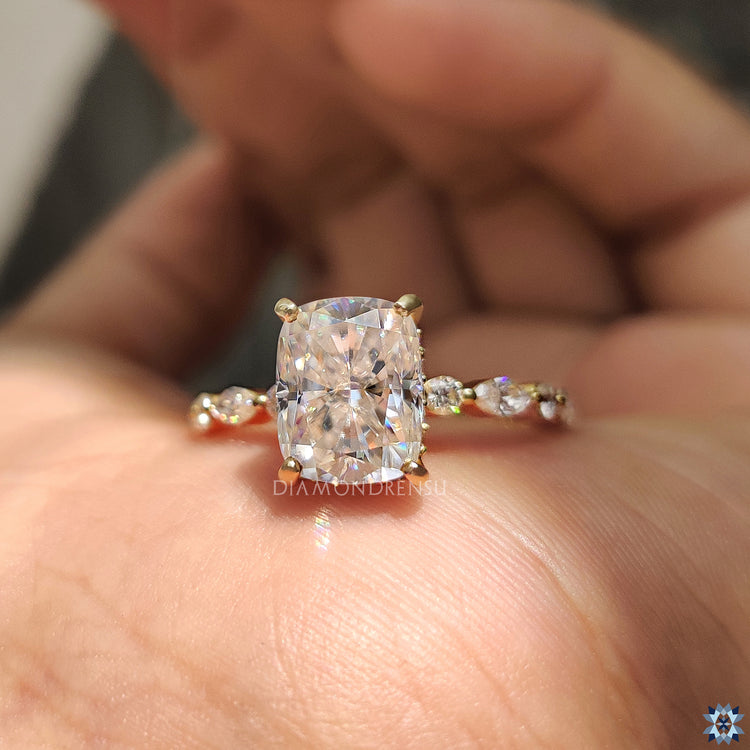 4 prong setting holds the cushion cut stone securely.