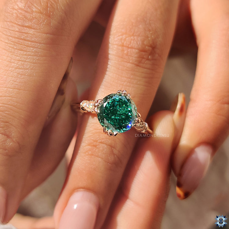 Diamondrensu ring with fishtail prong setting and round accents.