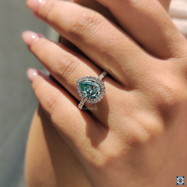 Moissanite Engagement Ring in a white gold bezel set with pave design.