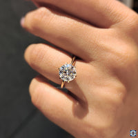 Solitaire ring with a round cut moissanite stone, set in a sleek, polished band for a simple yet sophisticated look.