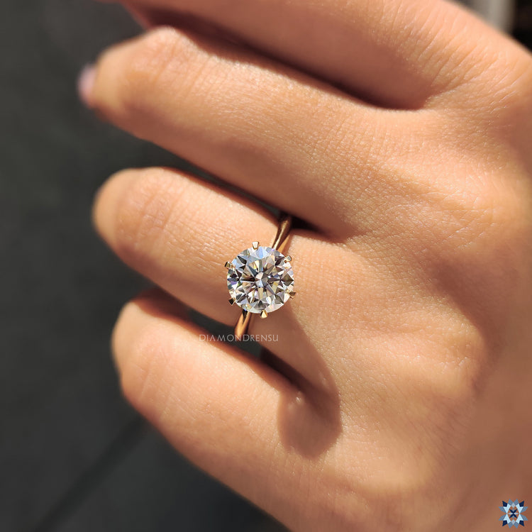 Solitaire ring with a round cut moissanite stone, set in a sleek, polished band for a simple yet sophisticated look.