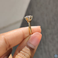 Solitaire round cut engagement ring, offering a stunning moissanite stone set in a refined six-prong setting.