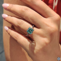 Cyan blue cushion cut moissanite ring, featuring vibrant hues and exceptional clarity for a one of a kind piece.