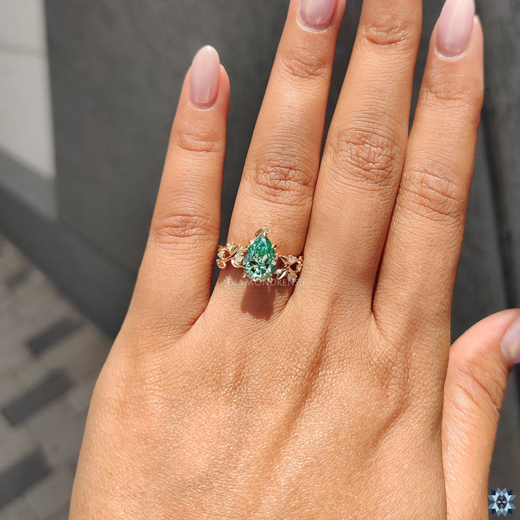 Prong setting ring with a pear cut moissanite stone, designed for a secure and dazzling look.