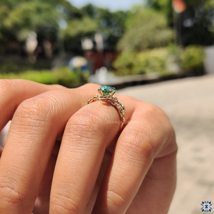 Yellow gold ring featuring a pear cut moissanite stone, offering a warm and classic design.