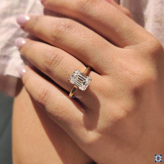 Solitaire ring with an emerald cut moissanite, perfect for a bold, yet classic statement.