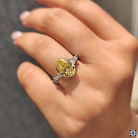 Handmade engagement ring featuring canary yellow pear moissanite.