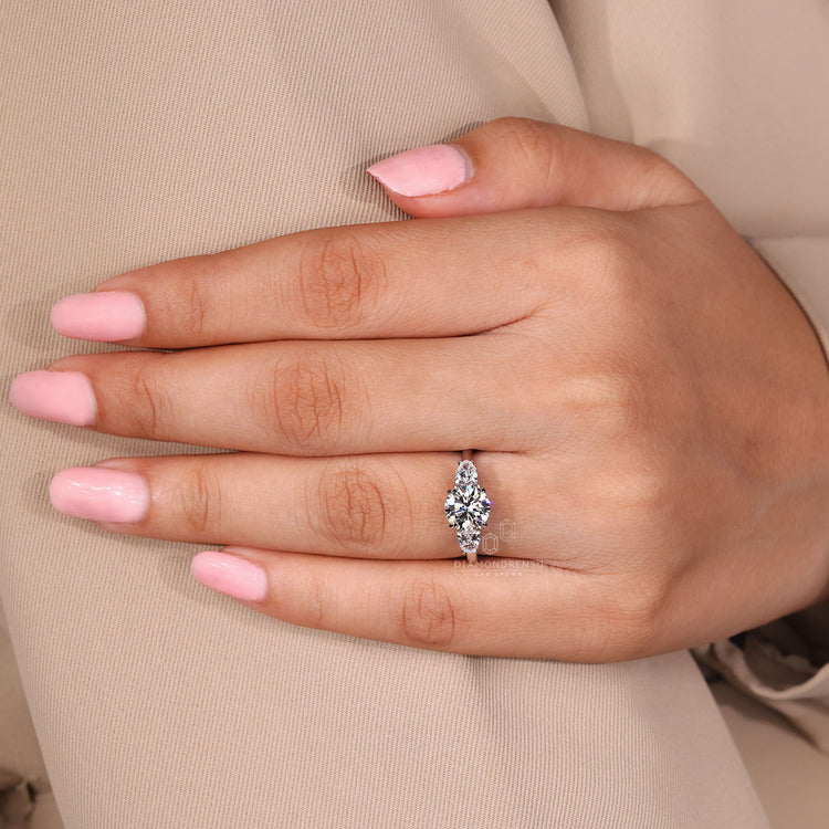 Anniversary gift three stone diamond ring with pear side stones.