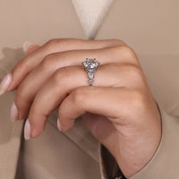 Custom engagement ring with round diamond and pear stones.