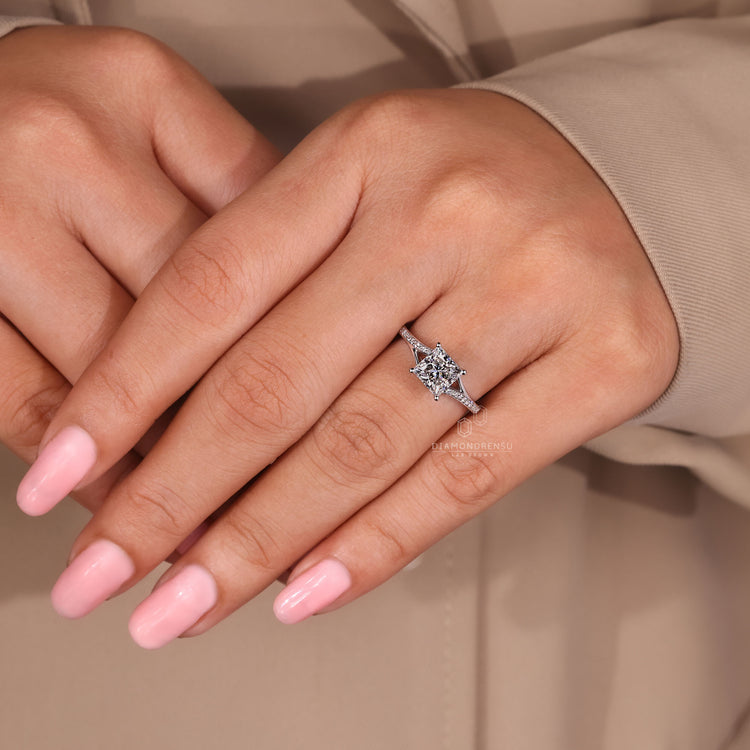 Lab-grown diamond engagement ring with pave setting and split shank design.