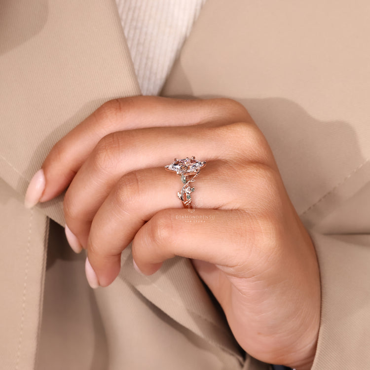 Leaf-style pave engagement ring with marquise and round diamonds.