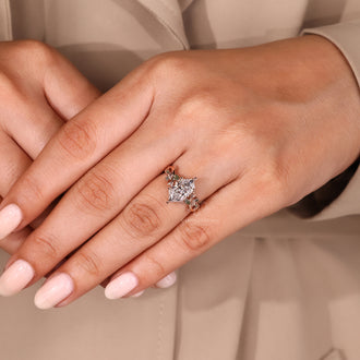 Rose gold engagement ring featuring moss agate and marquise accents.