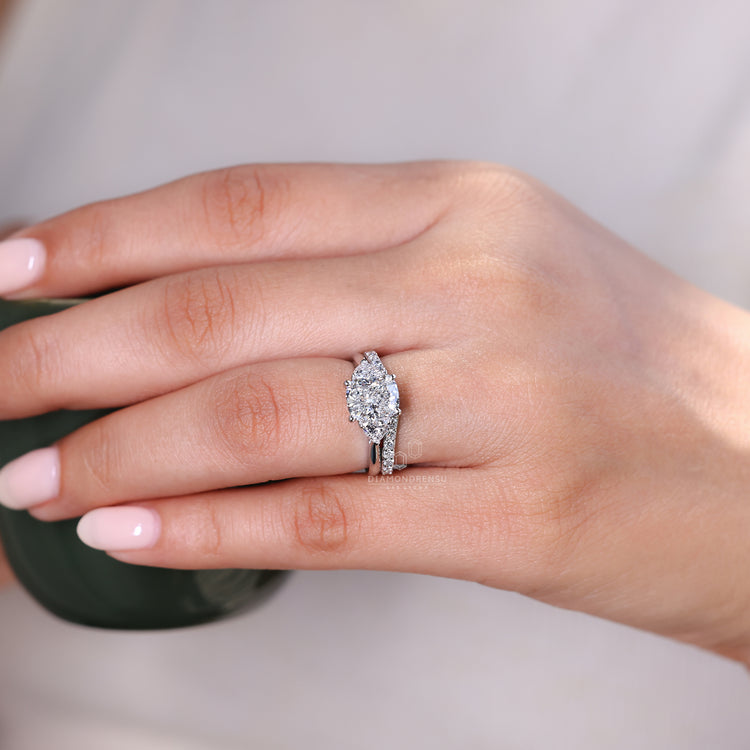 Handmade bridal set with a three stone ring and a sleek tapered shank band from Diamondrensu.