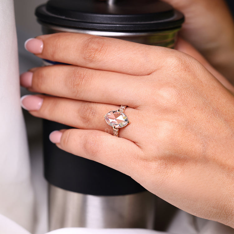 Round rose cut side stone with compass claw prong setting.