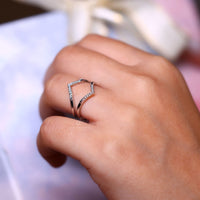 Ring enhancer wedding band with prong set diamonds.