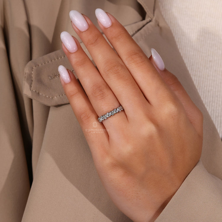 Handmade band crafted in white gold with round diamonds.