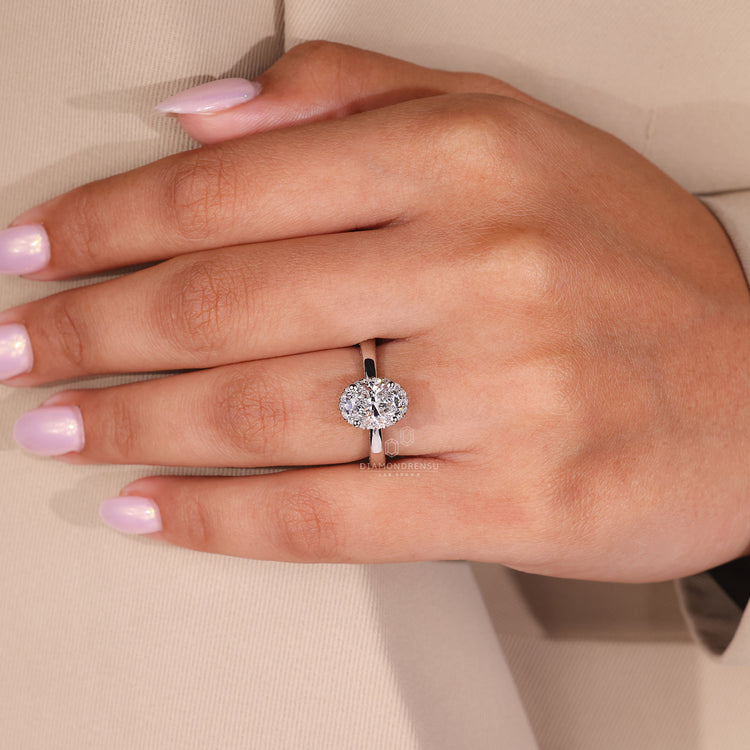 Round Cut Diamond Halo Setting Ring in white gold with tapered ring shank.