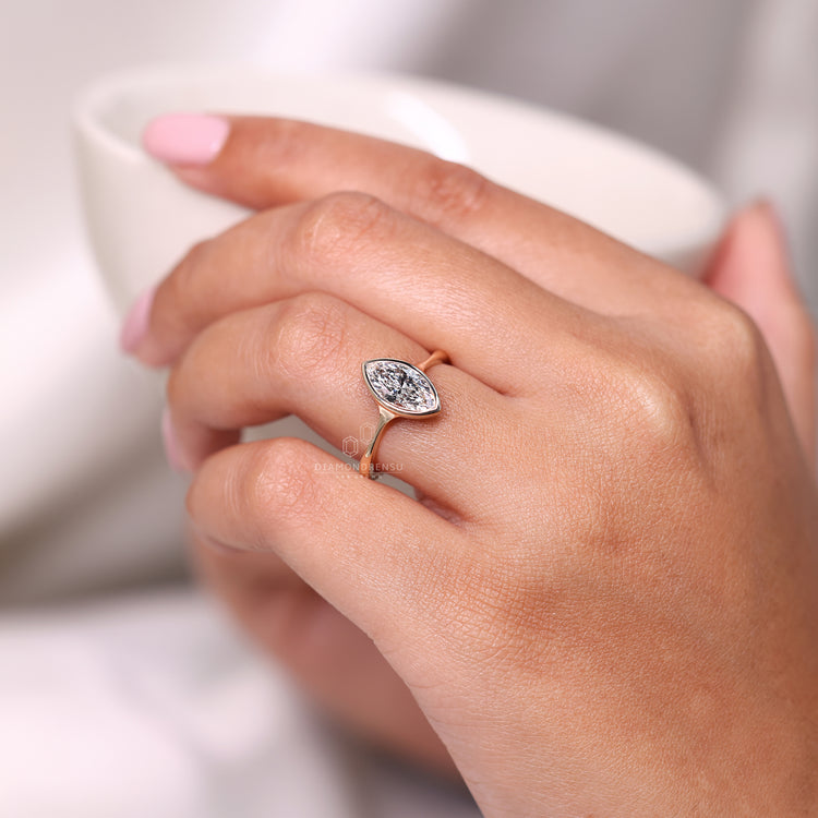 Bezel setting ring paired with a custom engagement ring.