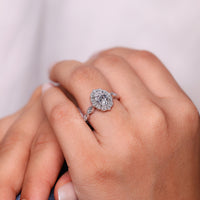 Round side stone ring in marquise outline design.