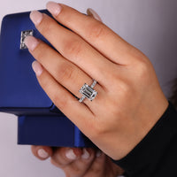 Pave round diamond ring with emerald cut center.