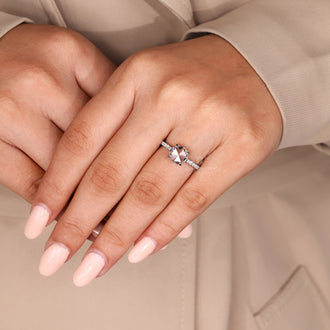 Four claw prong ring holding rose cut engagement diamond securely in place.