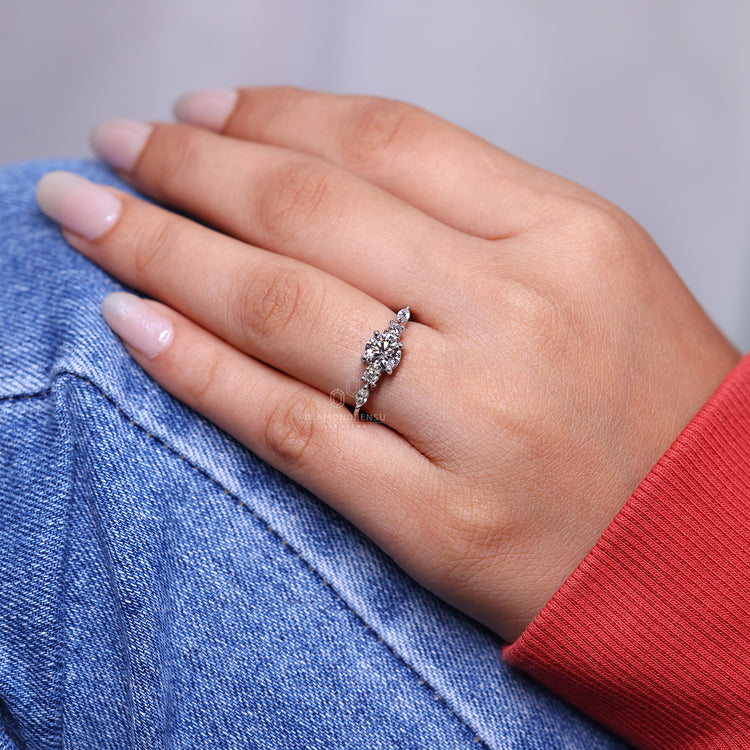 Handmade engagement ring with marquise and round side stones.
