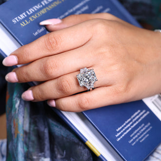 3 stone ring featuring trapezoid side stone and 4 claw prong ring.
