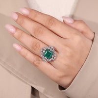 Halo ring with emerald center stone.