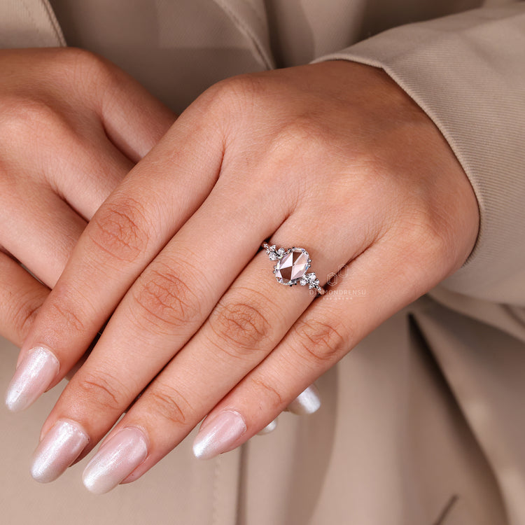 Buy engagement ring with oval rose cut diamond and round side stones.