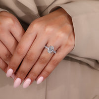 Round cut side stone adds extra brilliance to your engagement ring.