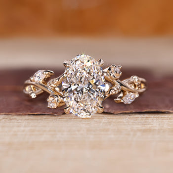 Oval cluster ring with marquise and round cut side stones