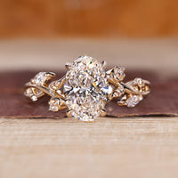 Oval cluster ring with marquise and round cut side stones