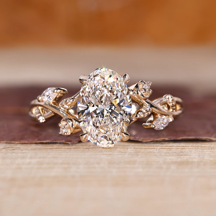 Oval cluster ring with marquise and round cut side stones