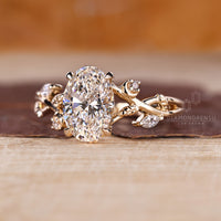 Custom yellow gold engagement ring with oval and marquise diamonds