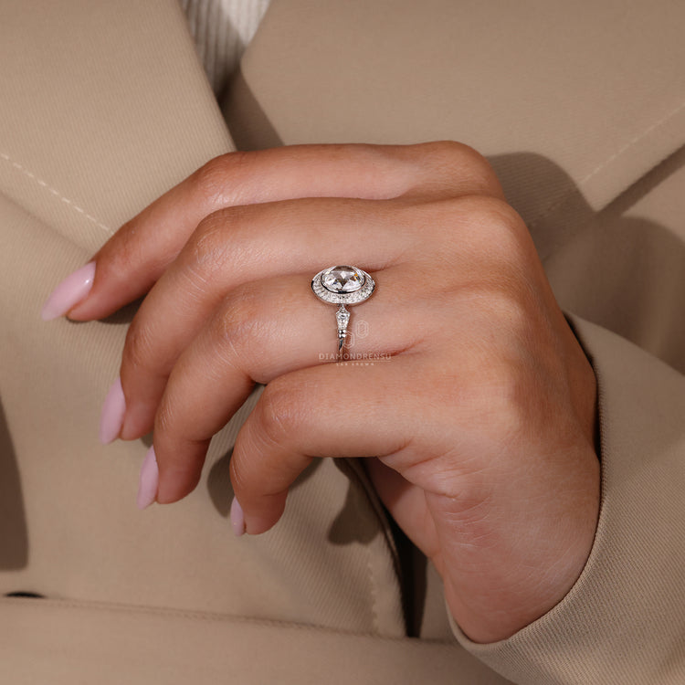 Handmade ring with bezel setting and round side stones.