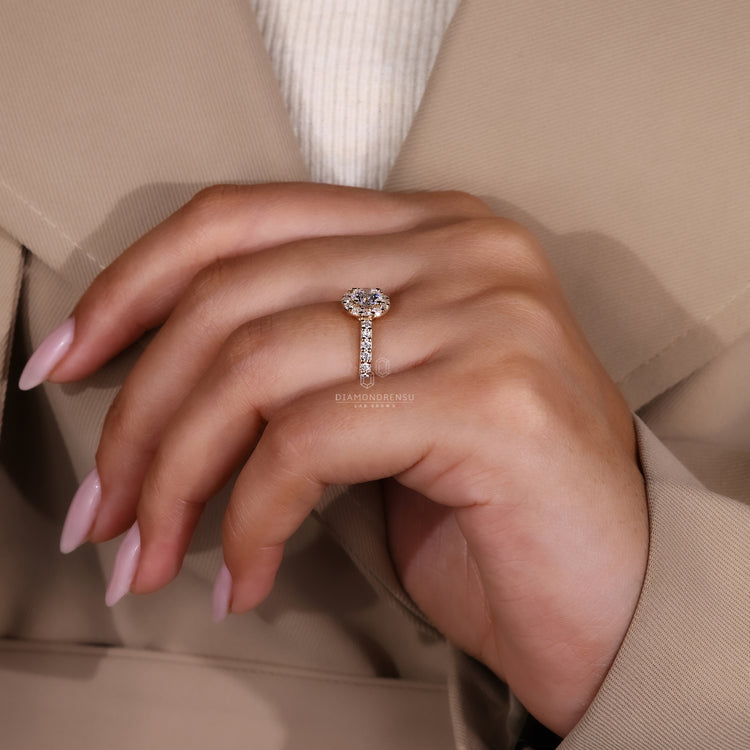 Round halo diamond ring with a pave band in yellow gold.