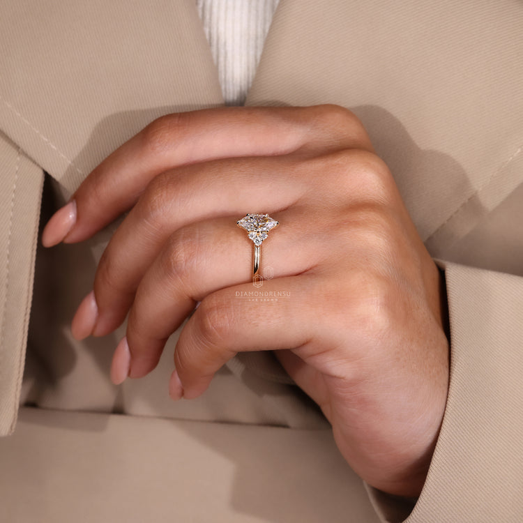 Round cut diamond side stones on marquise center solitaire ring.