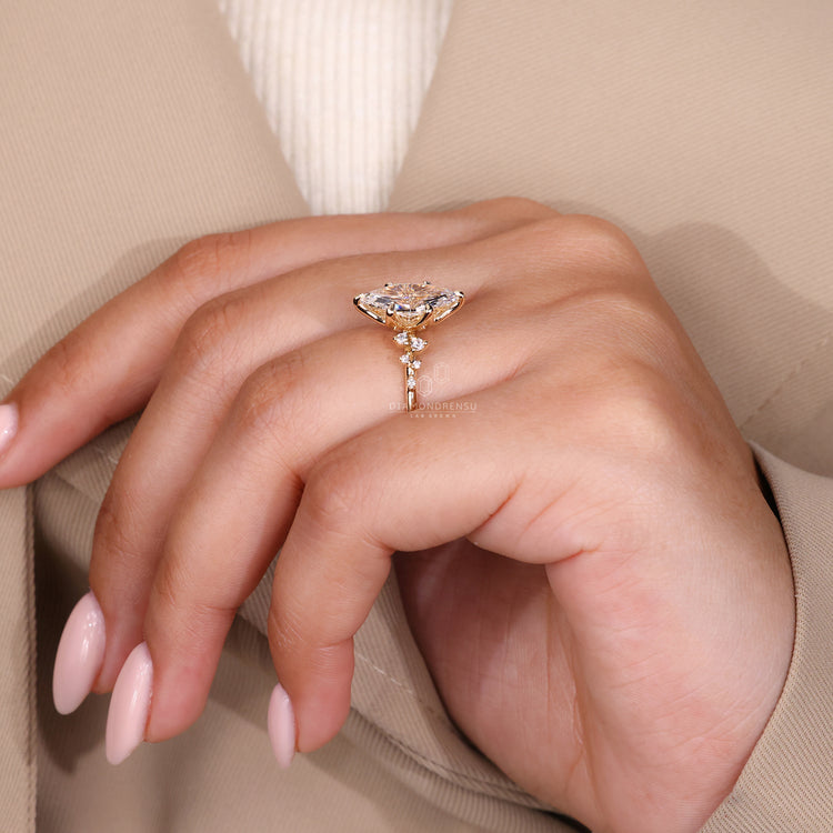 6 claw prong setting with marquise and round diamond side stones in a diamond ring and handmade jewelry design.