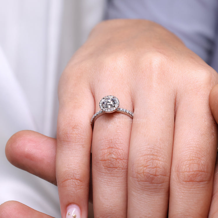 White gold engagement ring with round cut diamond center.