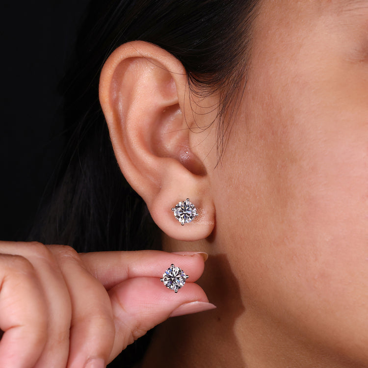 Round earrings studs featuring white gold jewelry and a 4 prong diamond stud setting.