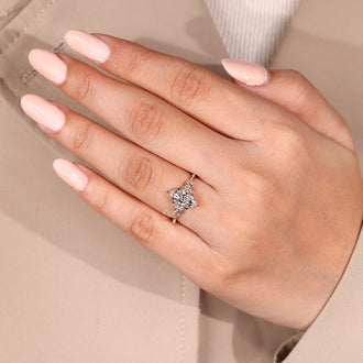 Custom diamond ring with marquise engagement diamond and kite round side stones.