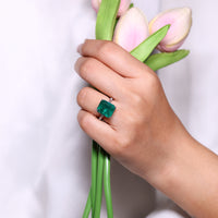 4 prong setting ring with emerald gemstone.