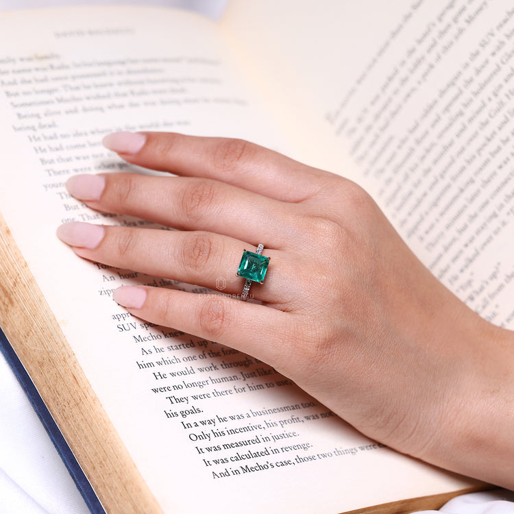 Emerald birthstone ring with diamond accents.
