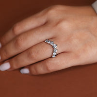 White gold U shaped band with round diamonds.
