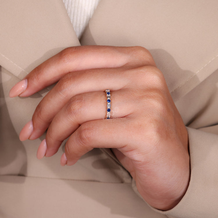 Yellow gold eternity band with sapphire stones.