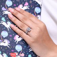 Hidden halo ring featuring radiant center diamond in white gold.
