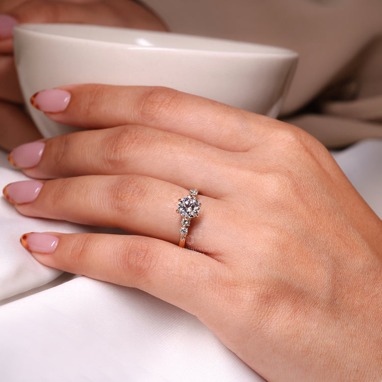 Handmade Jewelry with a round cut diamond side stone engagement ring in yellow gold.