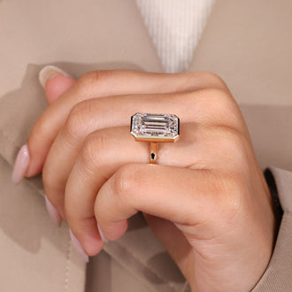 Cathedral setting emerald cut diamond ring.