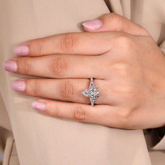 IGI certified handmade ring with pear cut diamond and round pave stones.